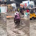 "Lagos, A state for hustlers" – Truck pusher unveils hustling spirit as he transports passengers amid fl00d in Computer Village, Ikeja (VIDEO) 