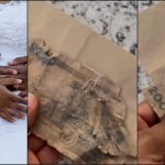 Newly wedded wife laments as she flaunts torn old N200 she saw in envelope as wedding gift